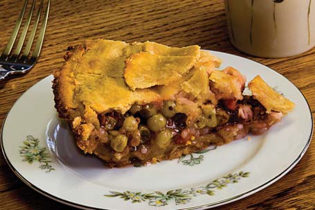 A close-up of a piece of gooseberry pie on a plate.