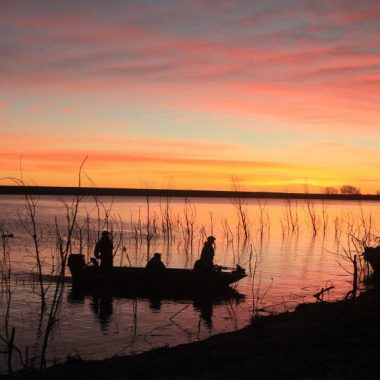 waterfowl hunters during sunrise.