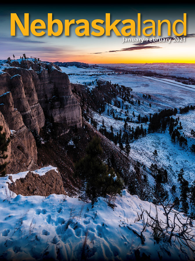 January-February 2021 Nebraskaland cover featuring a snowy landscape of Fort Robinson State Park at sunset.