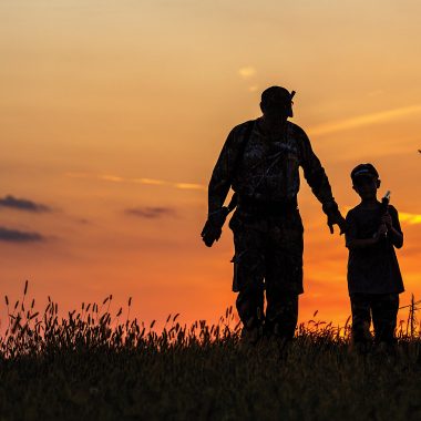 Man hunting with a young boy silhouette.