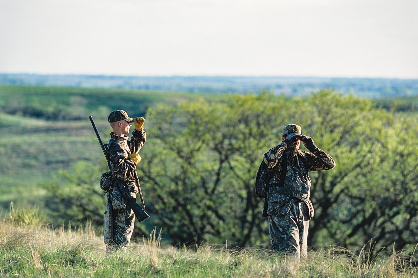 Two men turkey hunting.