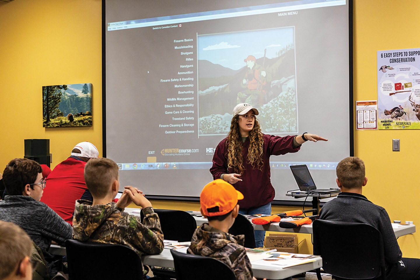 A female hunter education instructor teaching a hunt safe session.