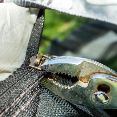 Pliers holds a tent zipper.