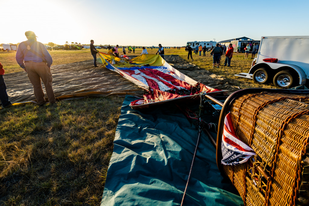 People prepare a hot air balloon for flight.