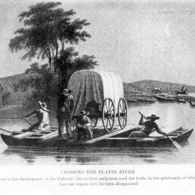 a wooden ferry helps a wagon train across the river