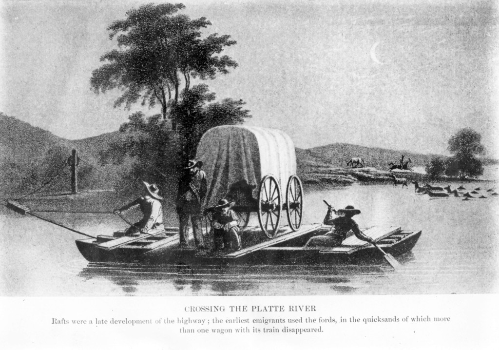 a wooden ferry helps a wagon train across the river