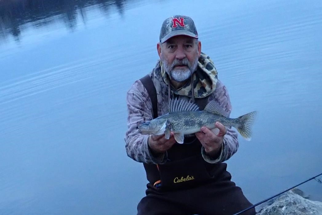 Angler holding a saugeye.