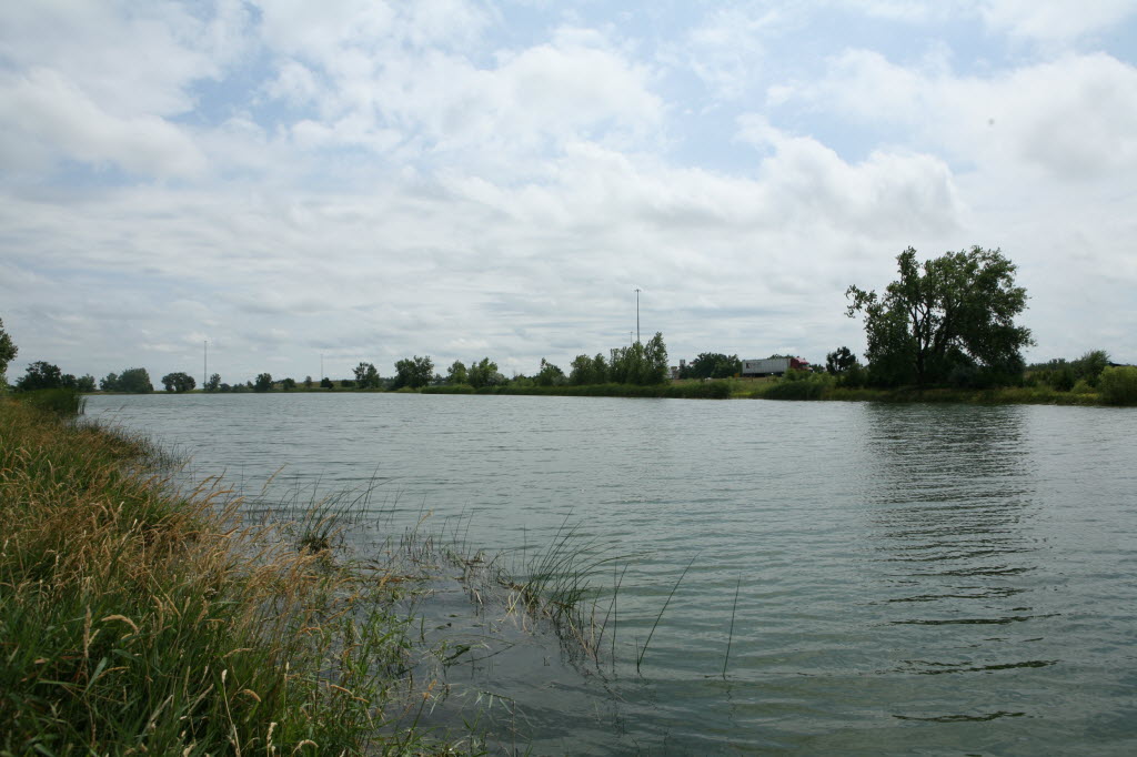 Gray waterbody under a cloudy sky.