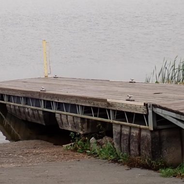 Boat dock beside boat ramp.