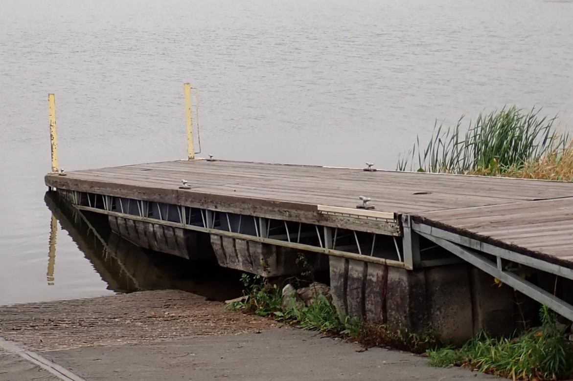 Boat dock beside boat ramp.