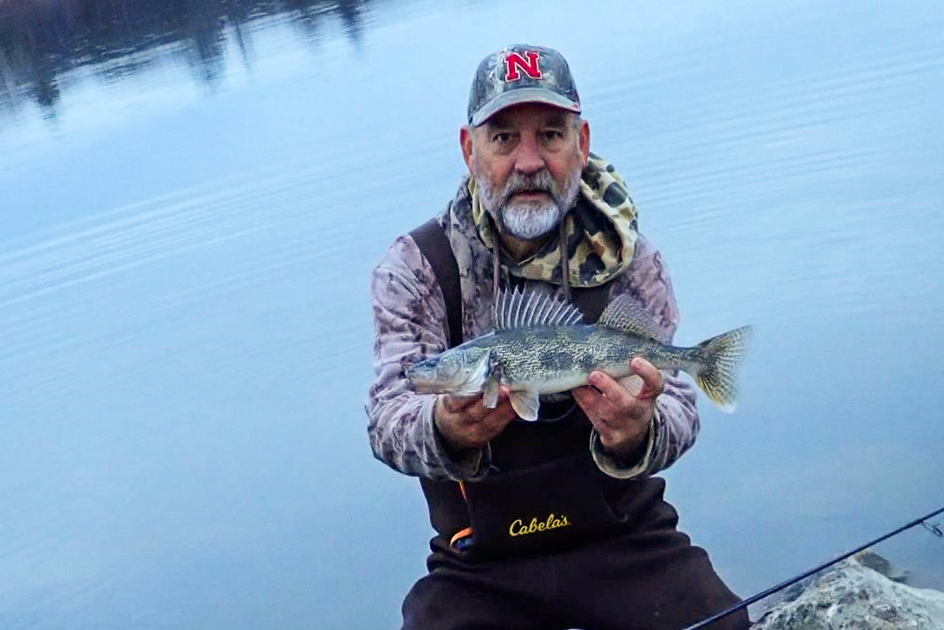 Angler holding a saugeye.