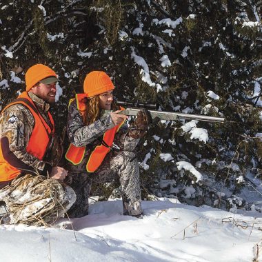 Man and woman hunting in the snow during the December muzzleloader season.