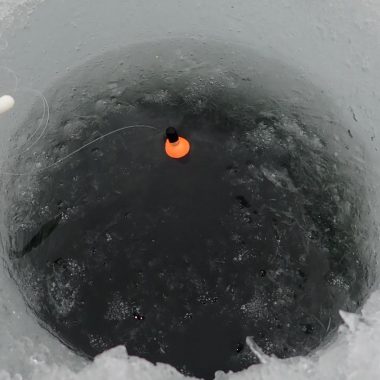 Bobber in an ice-fishing hole.