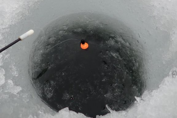 Bobber in an ice-fishing hole.