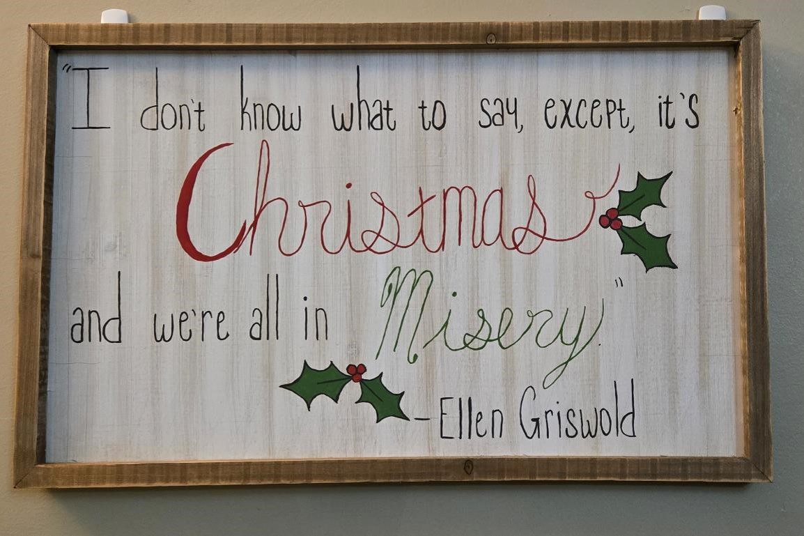 Christmas plaque hanging on wall.  Quote from Christmas Vacation movie.