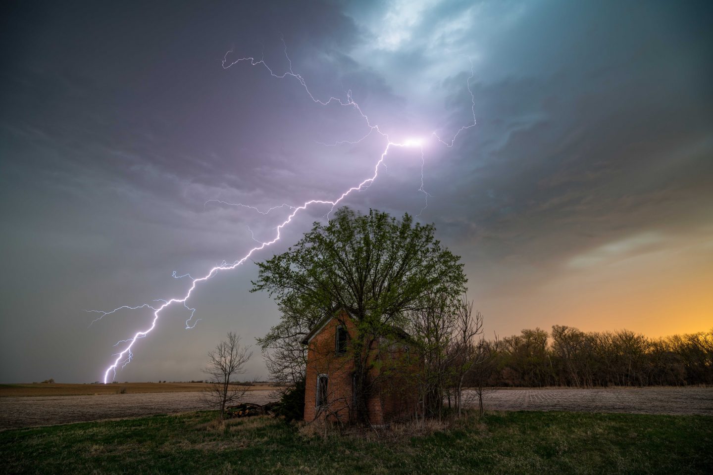 Lightning as backdrop of an old house.