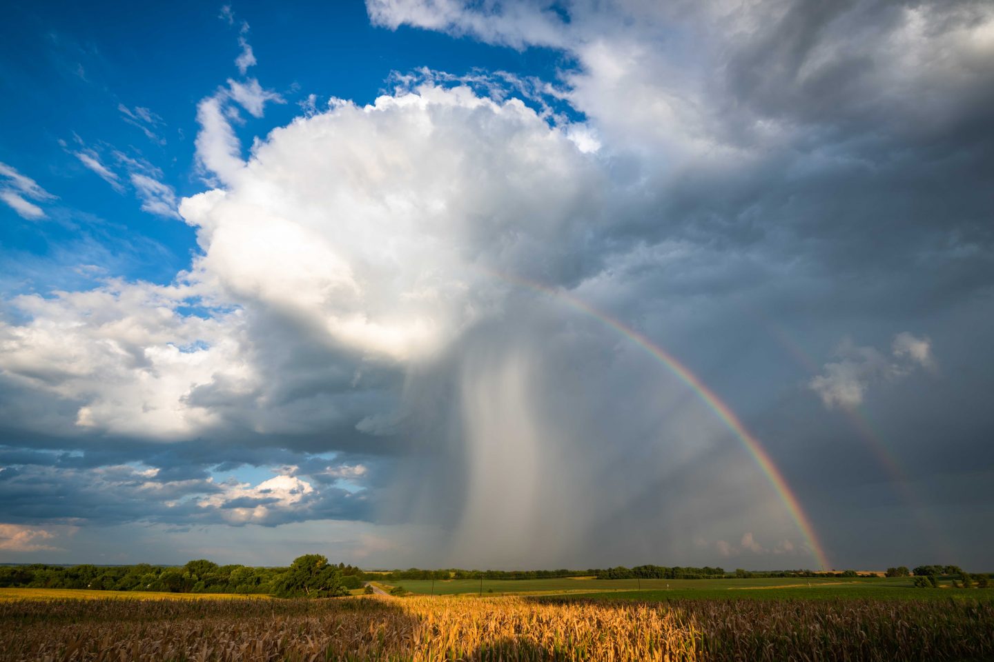 Rainbow underneath clouds.