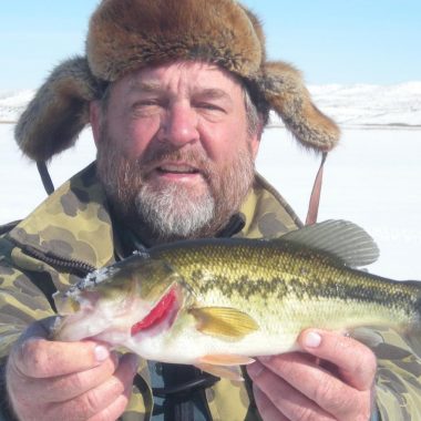 Ice angler with largemouth bass.