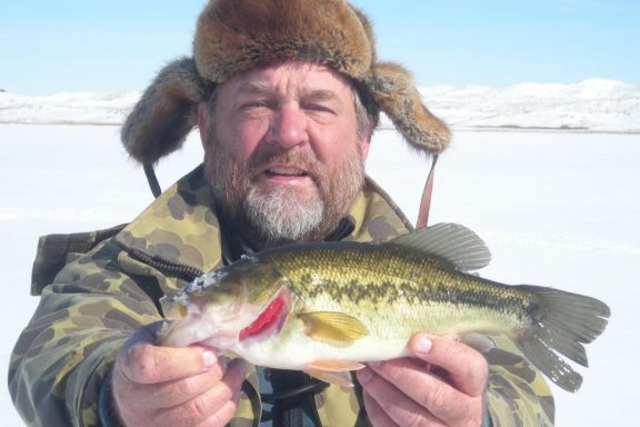 Ice angler with largemouth bass.