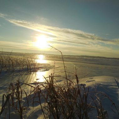 Sunrise over frozen lake.