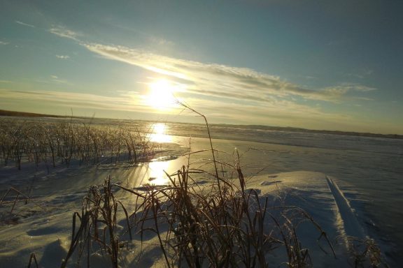 Sunrise over frozen lake.