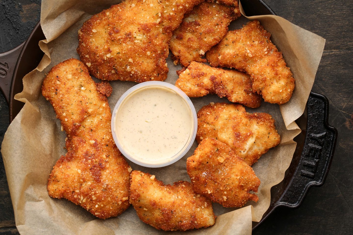 Fried bass with dipping sauce.