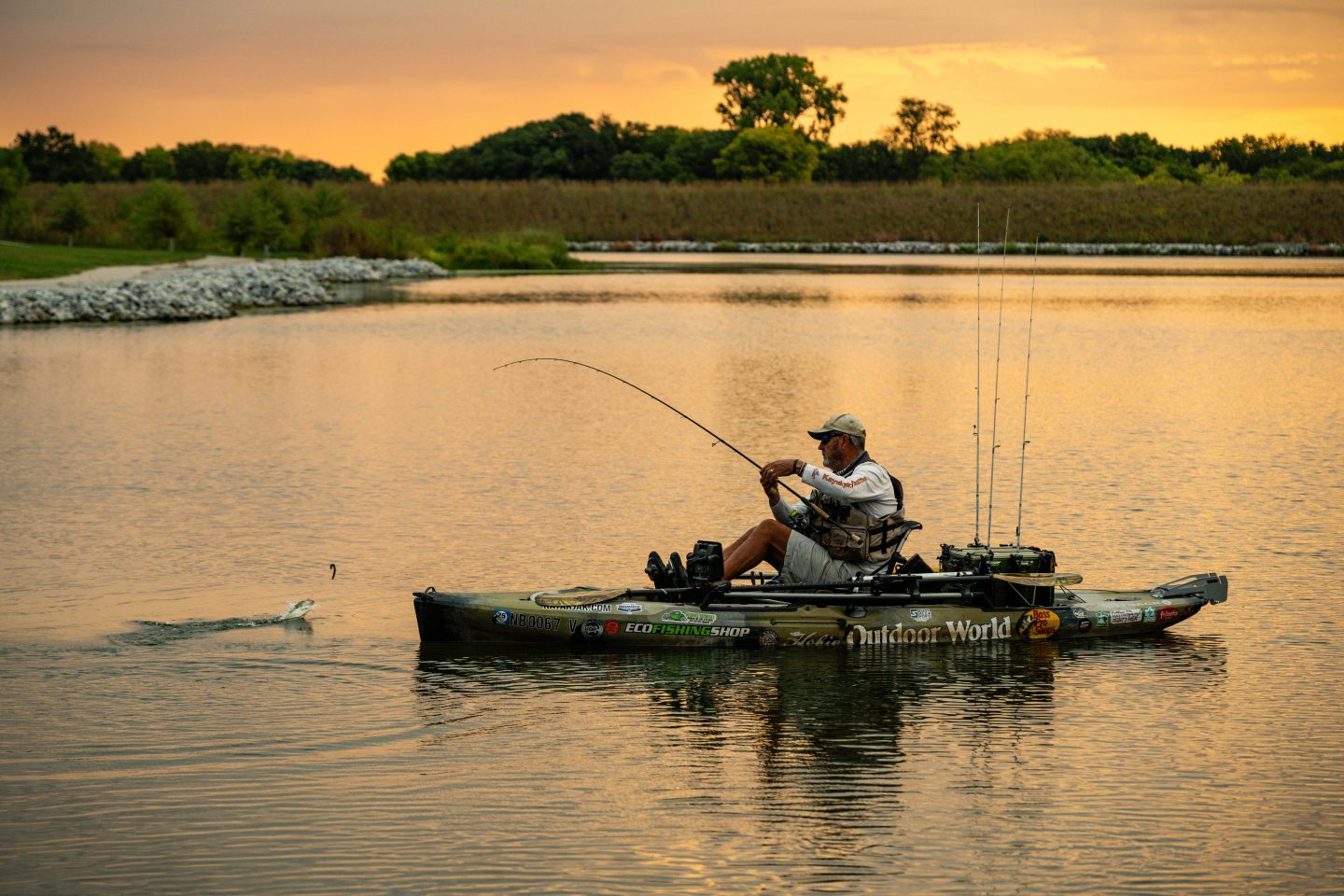 A man fishing out of a kayak.