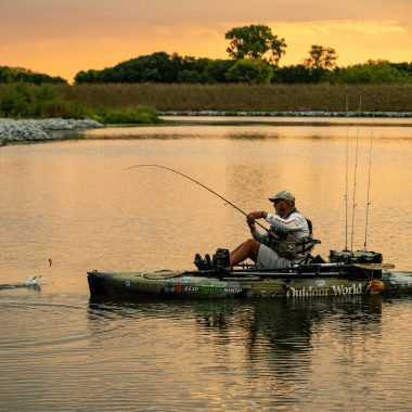 A man fishing out of a kayak.