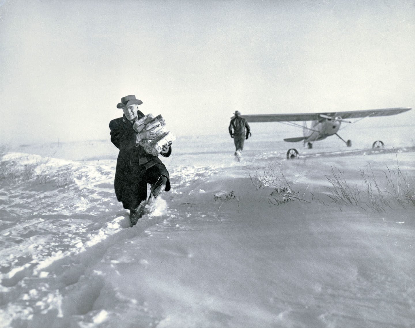 A man delivering bread in the snow.