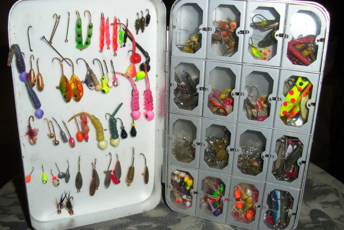 Tackle box full of ice fishing jigs.