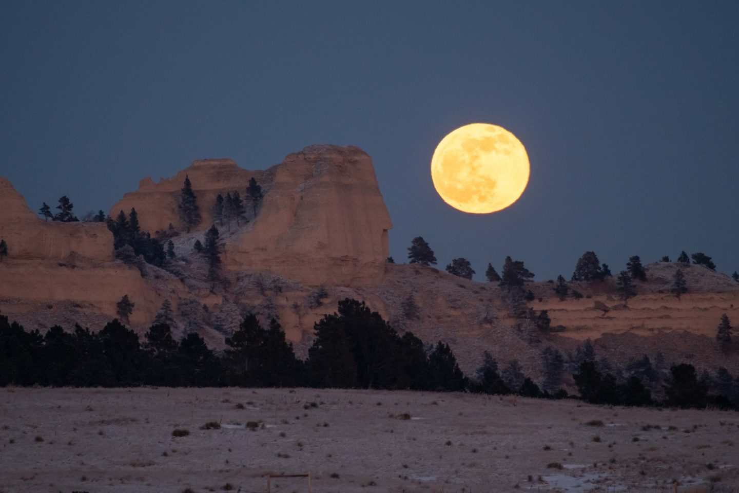 Full moon and Saddle Rock Butte at Fort Robinson State Park.