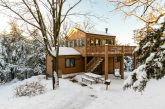 Cabin covered in snow in the winter.