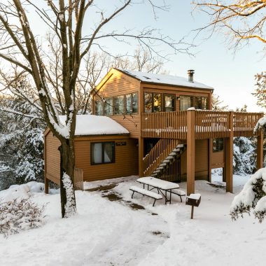 Cabin covered in snow in the winter.