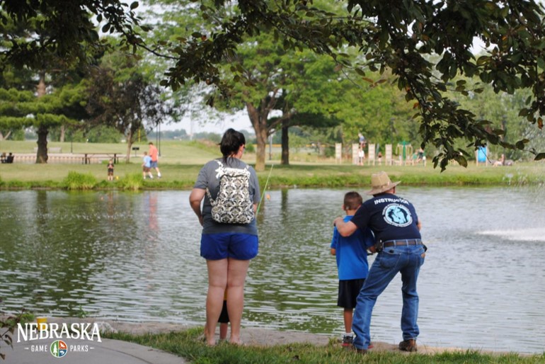 Anglers fishing a pond.