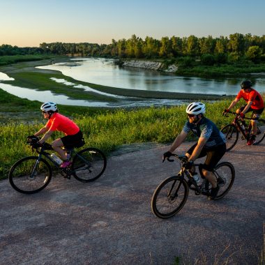 Two man and a woman bicycling on the Cowboy Trail near Norfolk.