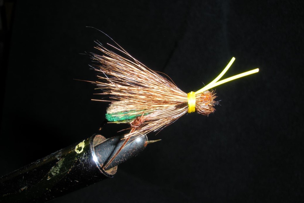 Hand-tied foam hopper fly on the vice.