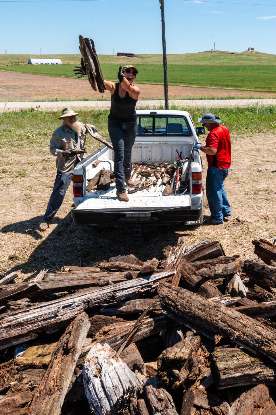 Volunteers piling railroad ties from the Cowboy Trail.
