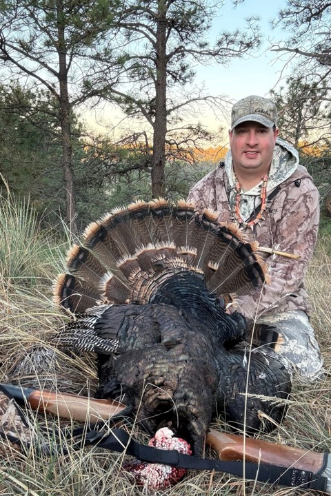 Successful Nebraska hunter posing with his turkey.