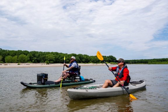 Two men kayaking on the Loup River Water Trail.