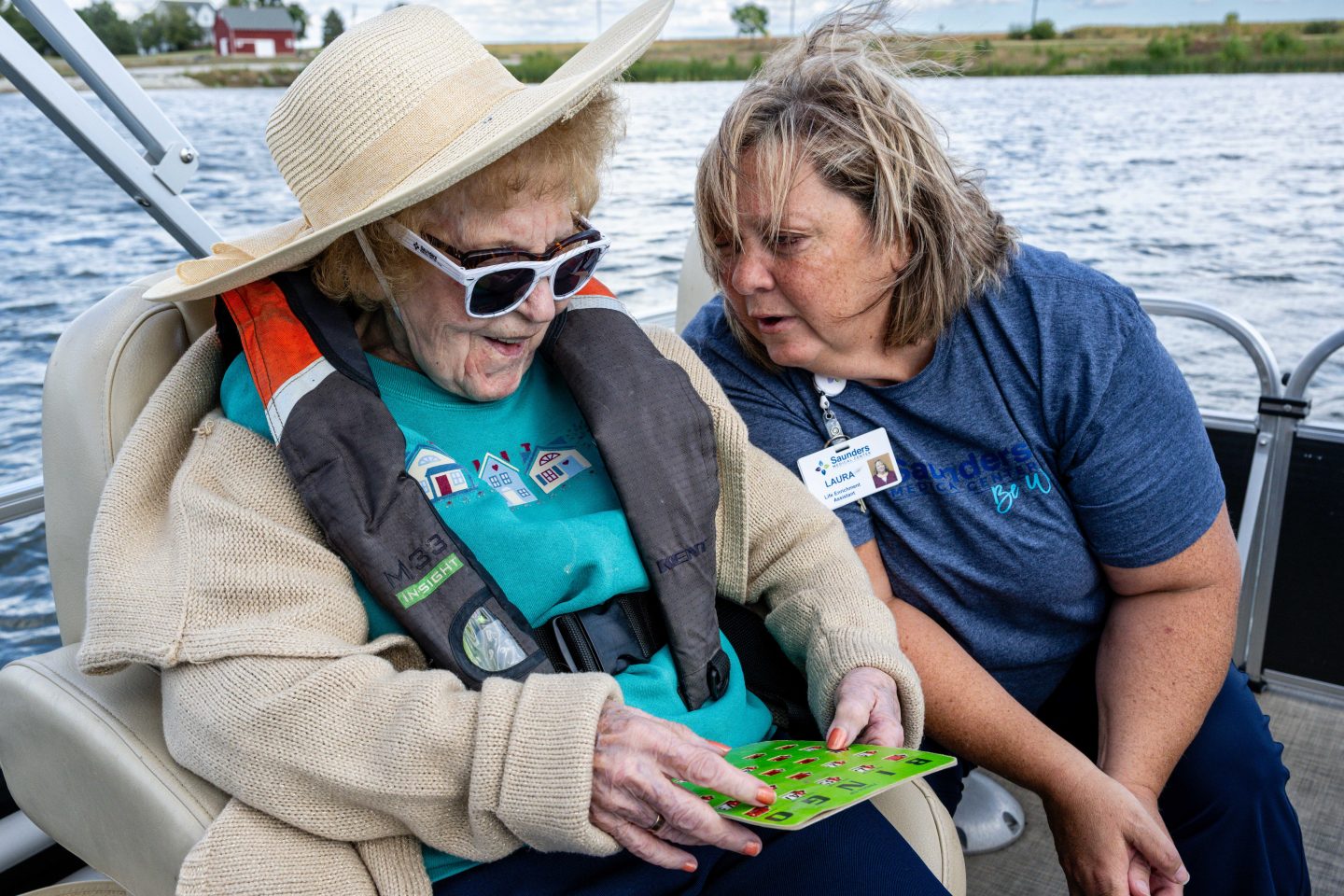 Laura Eivins, enrichment coordinator at Saunders Medical Center, chats with resident Dorothy Sorensen during a game of Bobber Bingo.