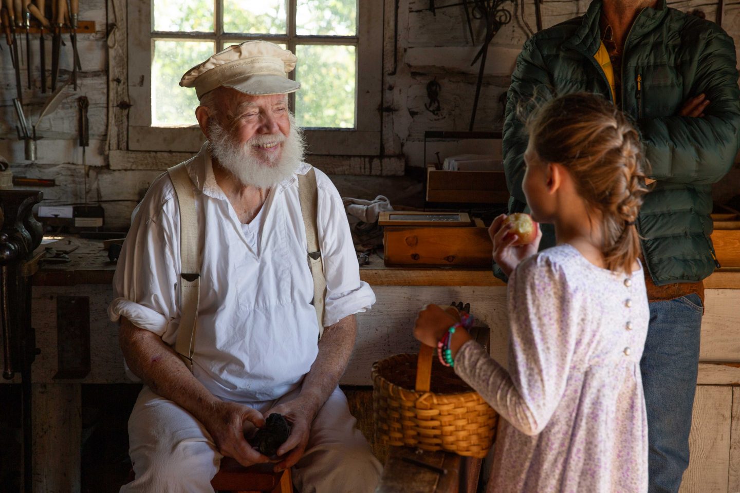 The late blacksmith Tom McDowell speaking to visitors during a living history event. He often sat in this corner, Slader said, making Fort Atkinson medallions. Visitors who purchased one at the shop could have their initials stamped on it.