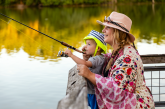 A mother and young son fish off a fishing pier.