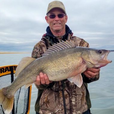 Angler holding big walleye.