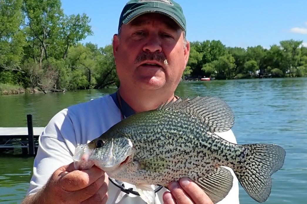 Angler holding a black crappie.