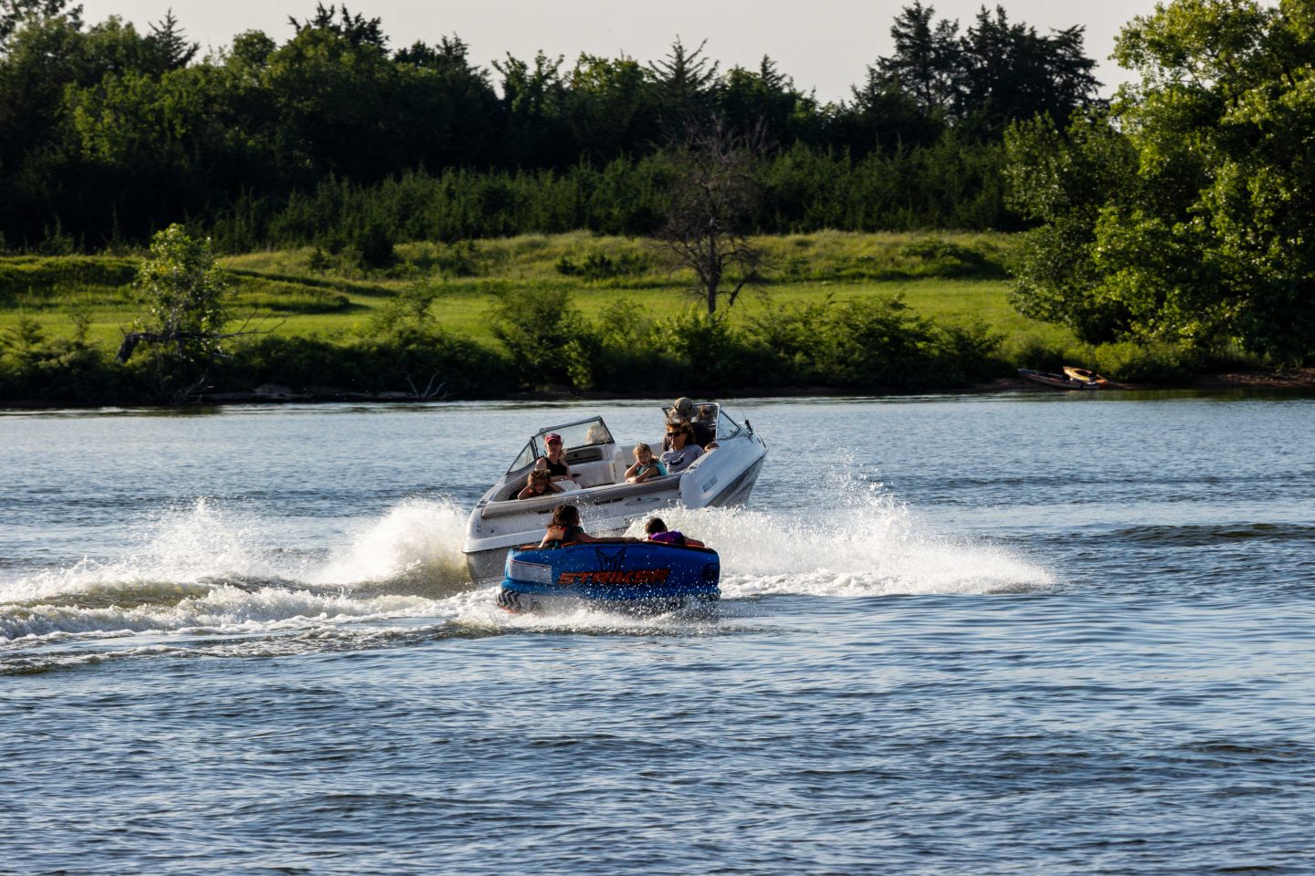 Midweek boaters pulling tubers have the entire lake to themselves.