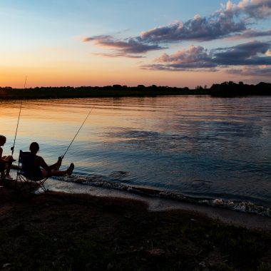 Skarlett Jones of Gretna and Delaney Madson of Lincoln fish from the bank at Rockford Lake State Recreation Area in Gage County.
