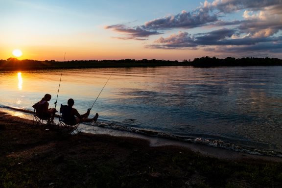 Skarlett Jones of Gretna and Delaney Madson of Lincoln fish from the bank at Rockford Lake State Recreation Area in Gage County.