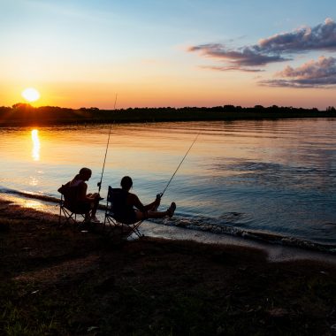 Skarlett Jones of Gretna and Delaney Madson of Lincoln fish from the bank at Rockford Lake State Recreation Area in Gage County.