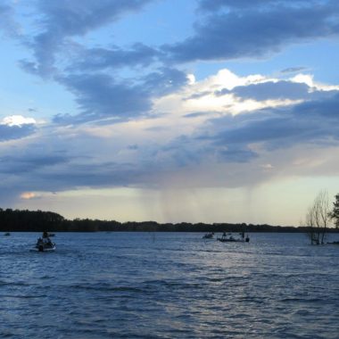 Early morning fishing boats on a reservoir.
