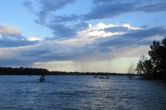Early morning fishing boats on a reservoir.